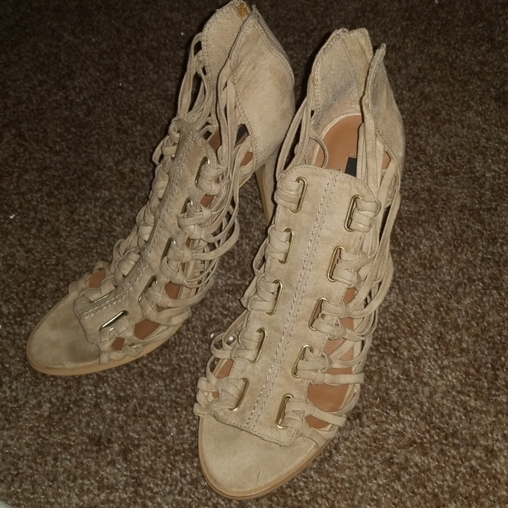 Beige colored zip up heels.